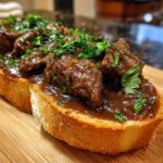 Close-up of Best Beef Manhattan served on toasted bread, garnished with fresh parsley.