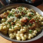 Bowl of Garlic Parmesan Chicken Pasta with creamy sauce, grilled chicken, parmesan cheese, and parsley.