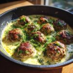Pan of Greek Meatballs in Lemon Sauce, garnished with fresh dill.