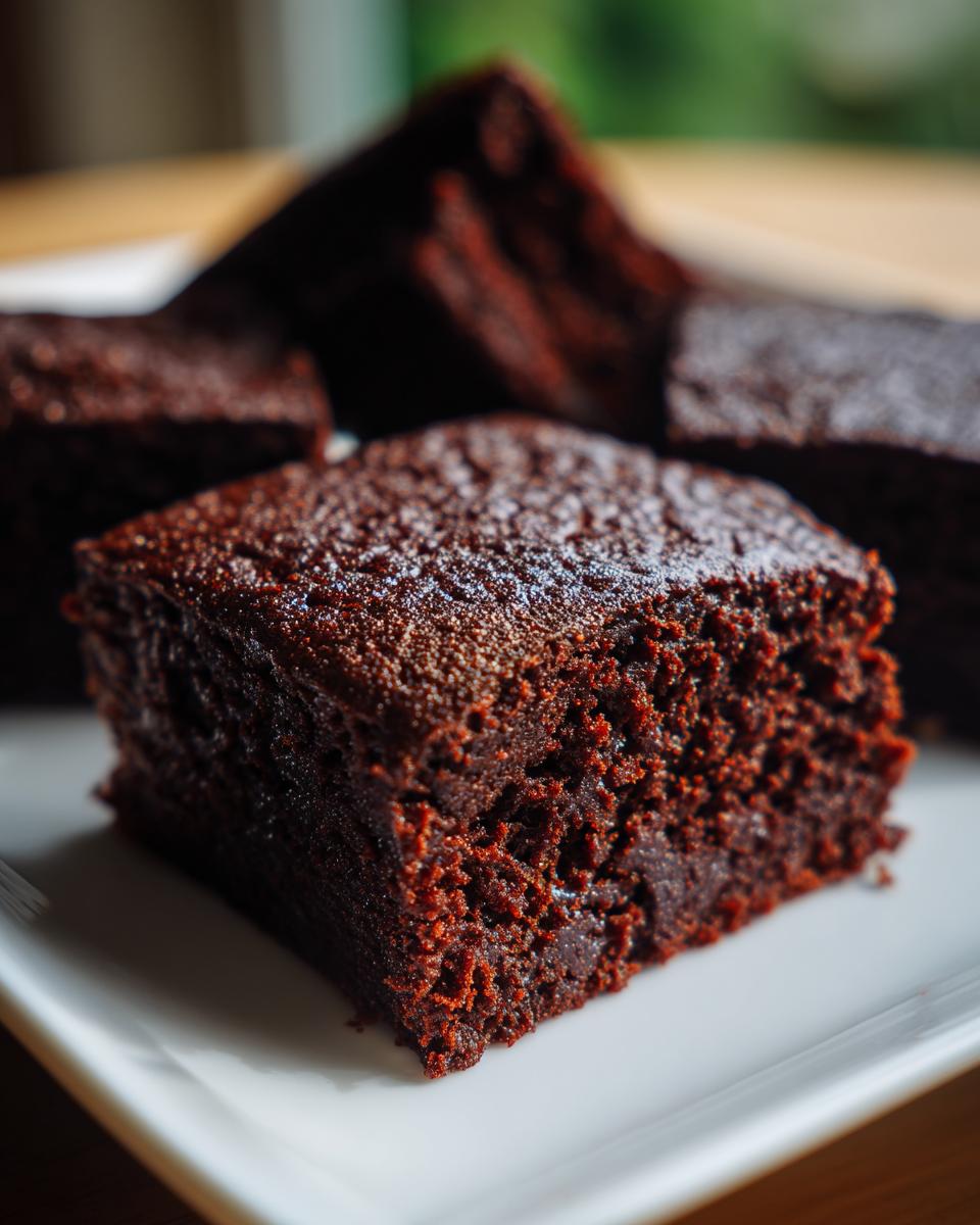 Close-up of a Healthy 87 Calorie Brownie on a white plate, showcasing its rich chocolate texture.