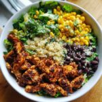 Overhead shot of a Healthy Chicken Taco Bowl with chicken, quinoa, corn, black beans, and lettuce.