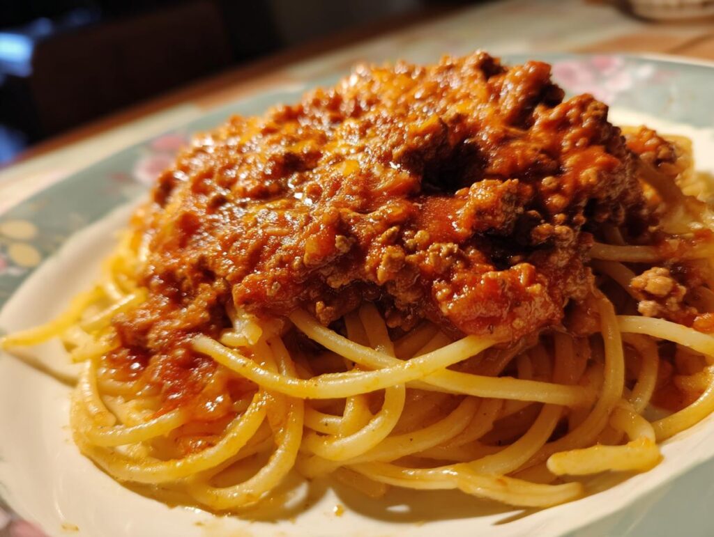 A plate of spaghetti topped with a rich, meaty sauce, showcasing the High Protein Beef Pasta dish.
