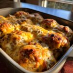 Close up of baked Keto Philly Cheesesteak Rolls in a baking dish, topped with melted cheese.
