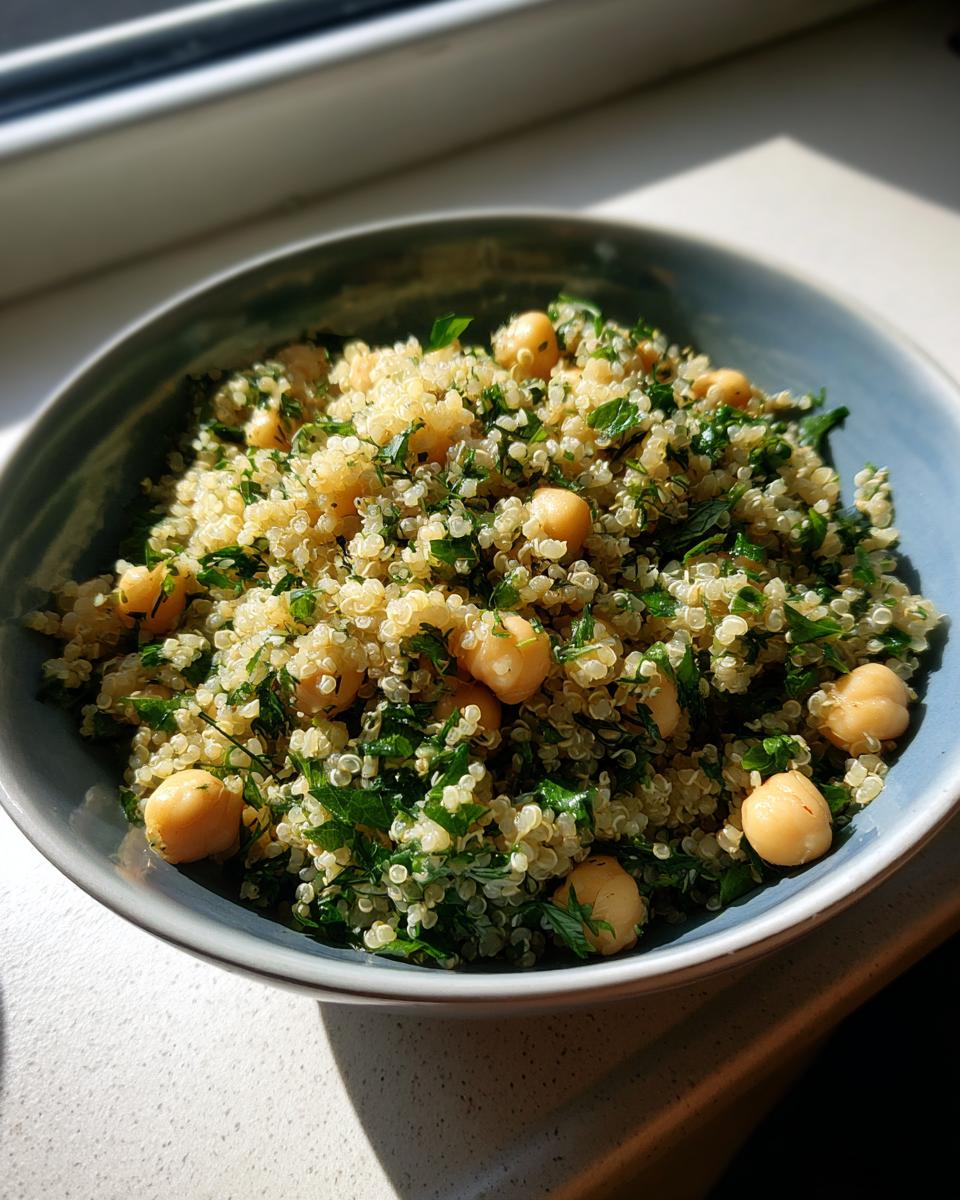 A vibrant bowl of Lemon Herb Quinoa Chickpeas, showcasing the fresh herbs and light lemon dressing.