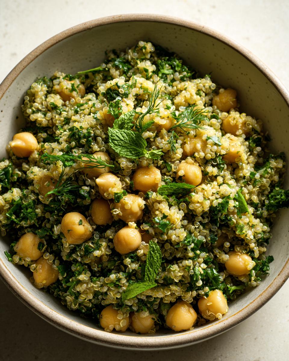Overhead shot of Lemon Herb Quinoa Chickpeas in a bowl, garnished with fresh herbs.