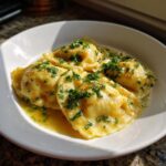 Close-up of Lobster Ravioli in Butter Sauce, garnished with fresh parsley.