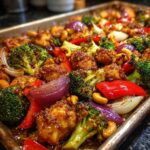 Sheet Pan Cashew Chicken with broccoli, red peppers, and red onion, roasted to perfection.