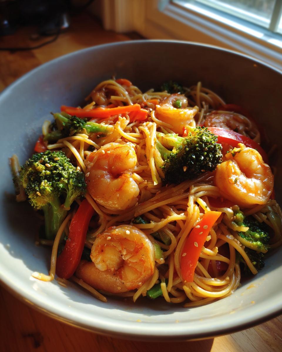 Bowl of Shrimp Stir with Noodles, featuring shrimp, broccoli, red peppers, and noodles.