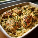 A delicious Classic Chicken and Rice Bake in a baking dish, garnished with parsley.