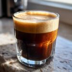 Close-up of a glass filled with DIY Irish Cream for Coffee, showing the creamy texture and dark color.