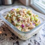 Close-up of Easy Tuna Salad Meal Prep in a clear glass container with celery and red onion.