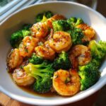 A bowl of Garlic Shrimp with Broccoli, featuring juicy shrimp and vibrant green broccoli florets.