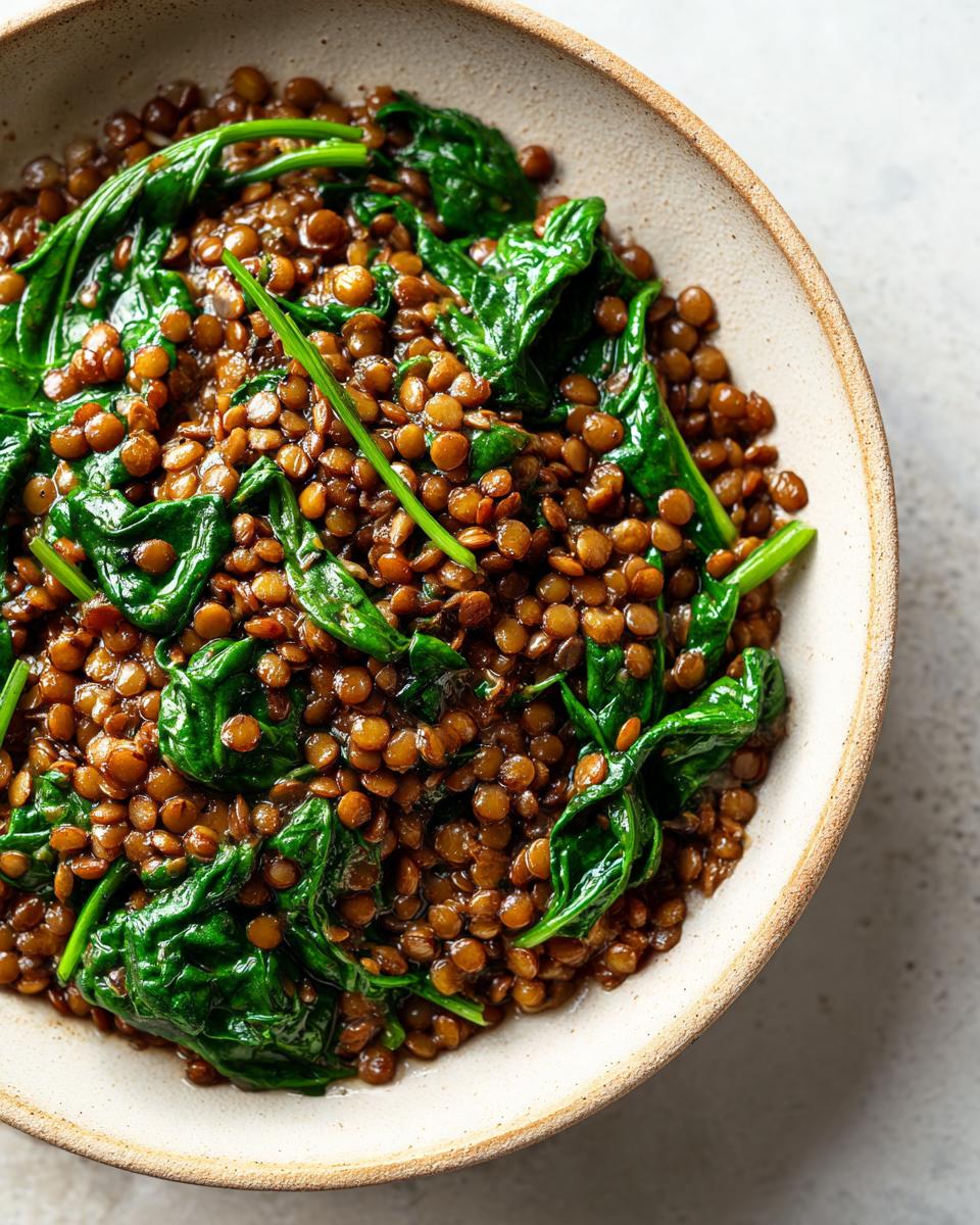 Overhead shot of a bowl filled with Lentil Stew with Spinach, highlighting the texture and vibrant colors.