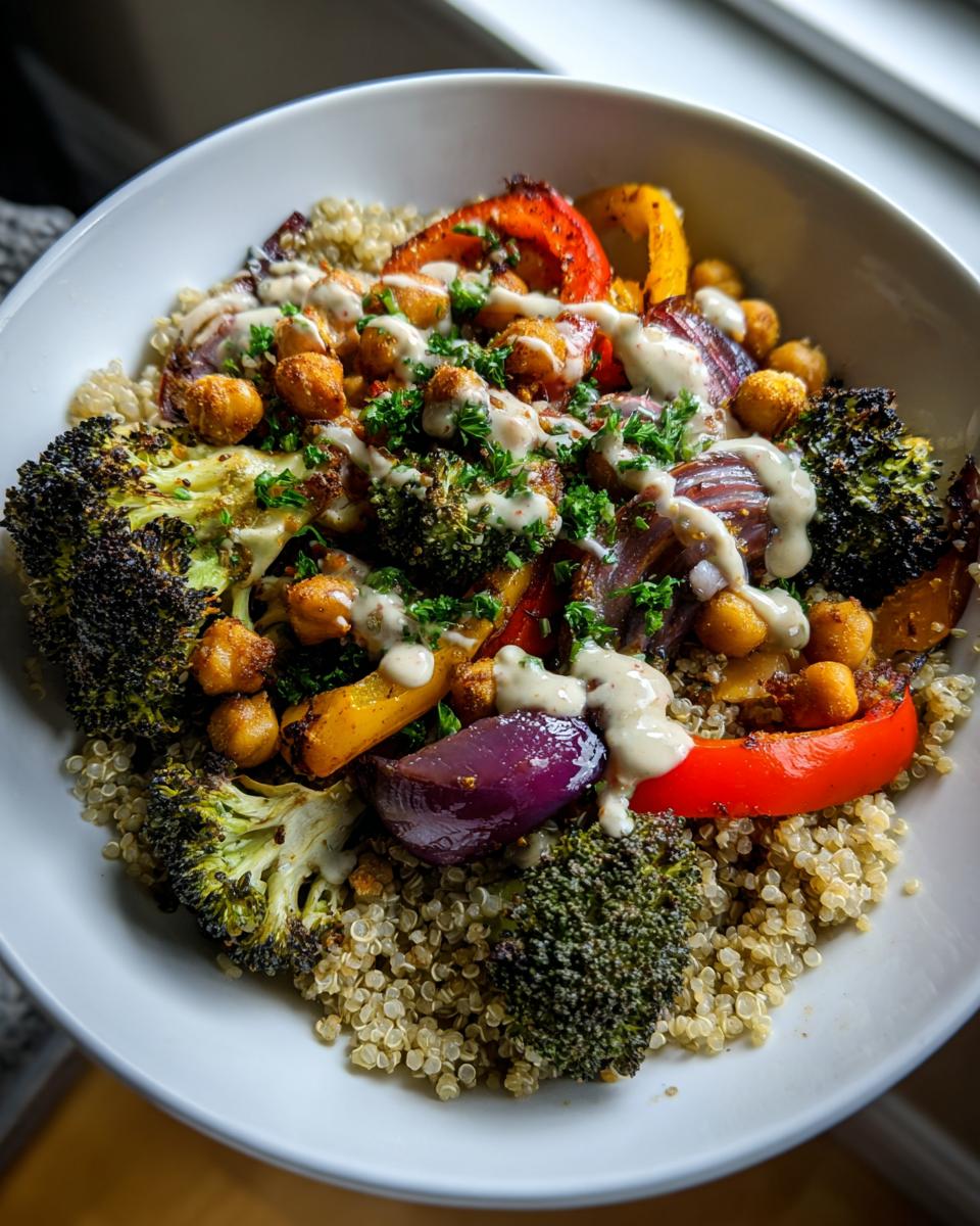 A vibrant Quinoa and Veggie Power Bowl with roasted broccoli, peppers, onions, chickpeas, and a creamy sauce.