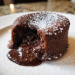 A decadent Chocolate Lava Cake with a molten chocolate center, dusted with powdered sugar.