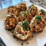 A plate of delicious cheese ball bites coated in bacon, nuts, and parsley.