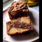 Close-up of a slice of Cinnamon Swirl Banana Bread showing a rich, dark cinnamon swirl center.