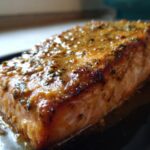 A close-up view of a perfectly cooked fillet of One-Pan Honey Mustard Salmon, glistening with sauce.