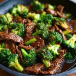 Close-up of Chinese Beef and Broccoli in a pan, featuring tender beef slices and vibrant broccoli florets in a savory sauce.