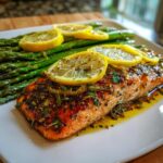 A delicious portion of lemon herb salmon served with roasted asparagus, a perfect light & nutritious dinner recipe.