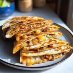 A stack of golden-brown Smashburger Quesadillas, filled with melted cheese and savory ground beef.