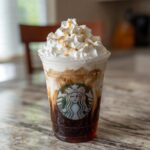 A delicious Starbucks drink with layers of coffee, cream, whipped cream, and caramel drizzle.