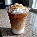 A refreshing caramel iced coffee from Starbucks, topped with whipped cream and caramel drizzle.