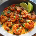A bowl of Spicy Cajun Shrimp with Smoky Seasoning, garnished with fresh parsley and lime wedges.
