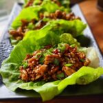 Close-up of Turkey Lettuce Wraps filled with savory ground turkey and topped with scallions and sesame seeds.