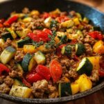A close-up of a Turkey and Veggie Skillet for Weeknights, featuring ground turkey, zucchini, bell peppers, and tomatoes.