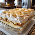 A delicious Easy Banana Pudding Dessert layered with vanilla wafers, creamy pudding, and topped with whipped cream and fresh banana slices.
